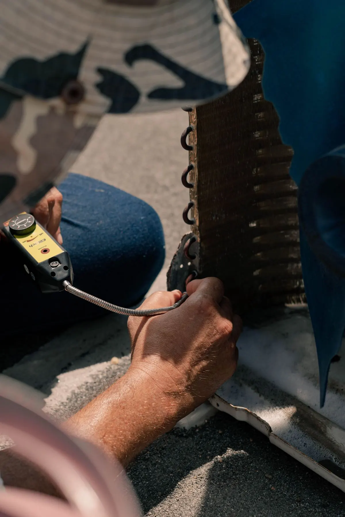 Technicians repairing an air conditioner